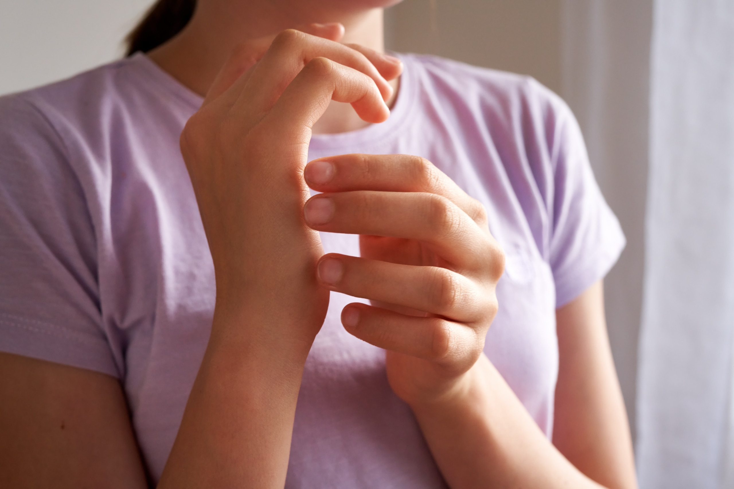 Teenage girl practicing EFT – emotional freedom technique – tapping on karate chop point